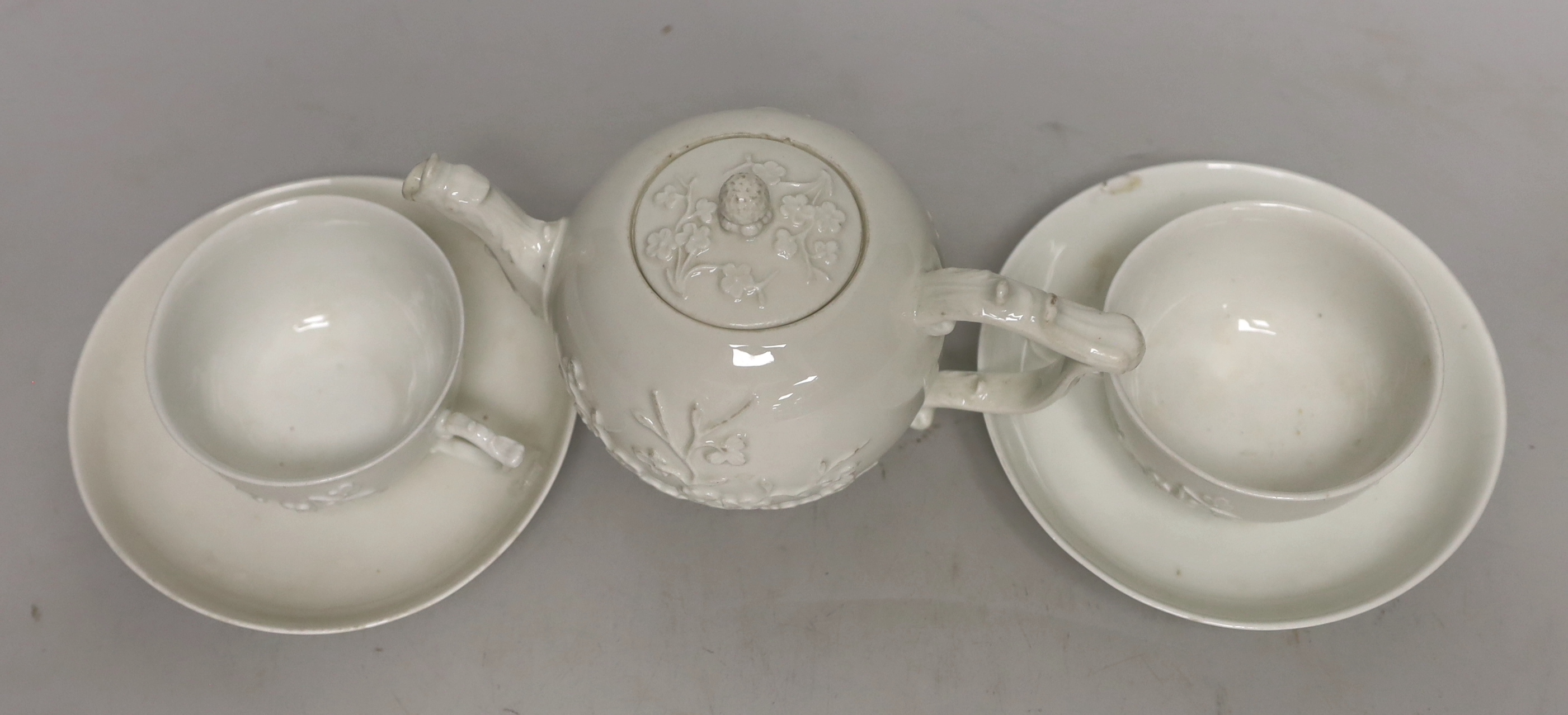 A 18th century Meissen teapot and two teacups and saucers, c.1740